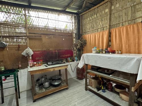 a kitchen with a table and a stove in it at Purple Orchid in Kāziranga