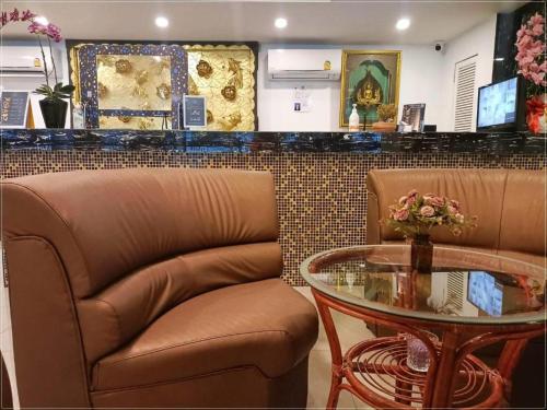 a bar with a table and a chair and a glass table at Rest@Ratchada hotel in Bangkok