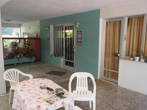 a dining room with a table and two chairs at Villa Anastasia Olympic Beach in Olympiaki Akti