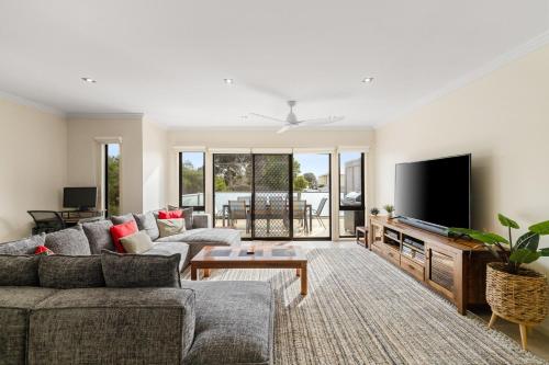 a living room with a couch and a tv at Brooklya by the Beach in Cowes