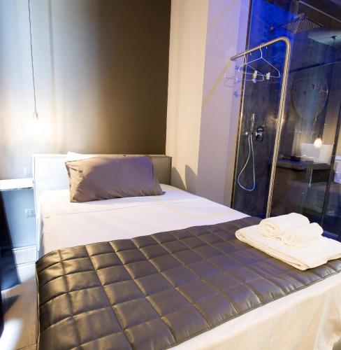 a bed with a shower and towels on it at Dimora Villareale in Palermo