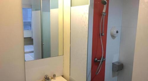 a bathroom with a mirror and a sink at 85 Beach Garden Hotel in Singapore