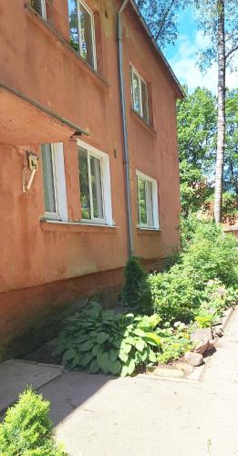 a house with a pool of water in front of it at Self check-in spacious apartment in a quiet area in Rīga