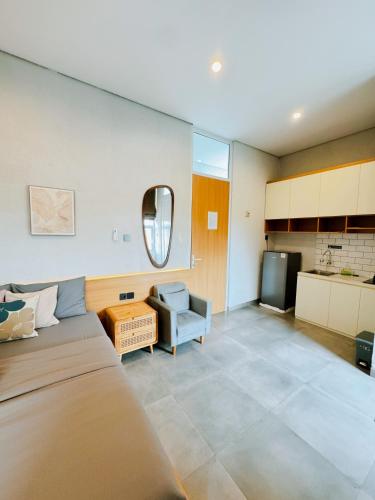 a living room with a couch and a tv at Casa de Java Cirebon in Tangkil