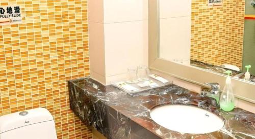 a bathroom with a sink and a toilet at Super 8 Hotel Quanzhou Xinchezhan Branch in Quanzhou