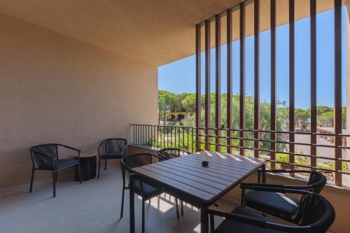 a balcony with a wooden table and chairs at Campoblù in Marina di Campo