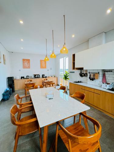 a kitchen and dining room with a table and chairs at Casa de Java Cirebon in Tangkil
