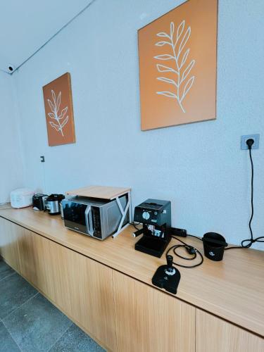 a counter with a microwave on top of it at Casa de Java Cirebon in Tangkil