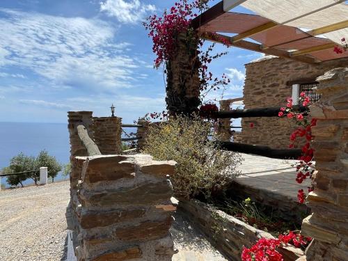a stone wall with flowers on the side of a building at Casa Crisantemo with sea view and pool in Adra in Las Hoyas del Barranco