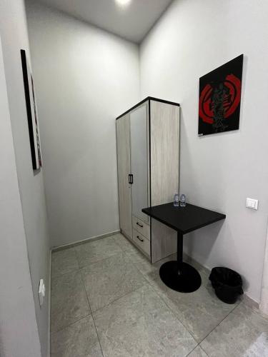a room with a black table and a cabinet at Safarov's Family Hostel in Tashkent
