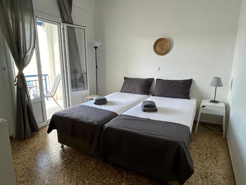 a bedroom with a large bed and a balcony at Kamara rooms in Naousa in Naousa
