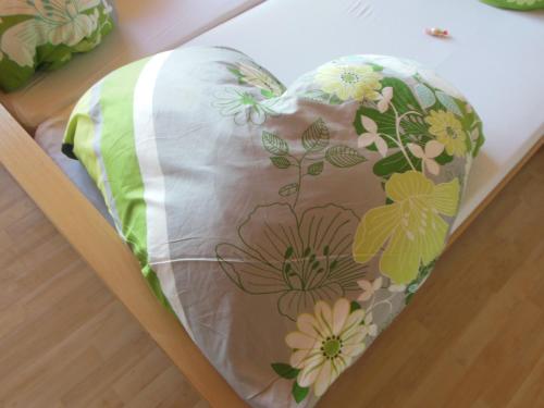 a pillow with flowers on it in a drawer at Pension Sonnhof in Radstadt
