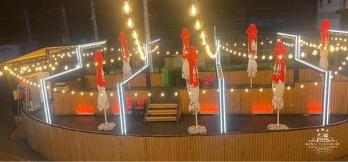 a stage with red and white umbrellas and lights at Hanul Ceaunelor Voronet in Voronet