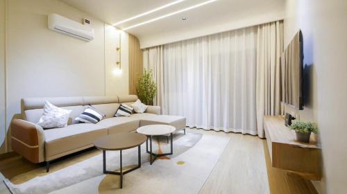 a living room with a couch and a tv at Amaltas The View - Bespoke Hotel Apartment in Kigali