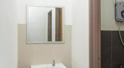 a bathroom with a sink and a mirror on the wall at SPOT ON 89757 The Rooms JB in Johor Bahru