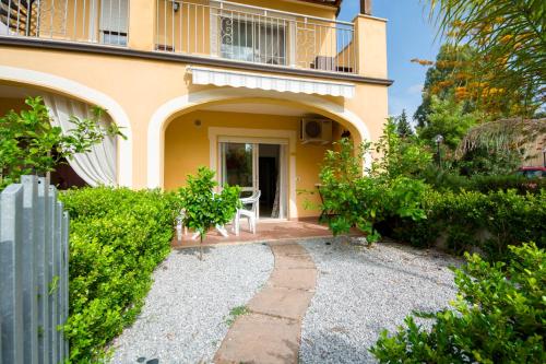 a house with a balcony and a table in front of it at Pizzo Beach Club in Pizzo