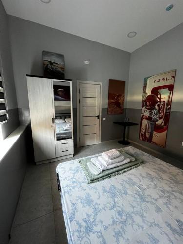 a bedroom with a bed and a refrigerator at Safarov's Family Hostel in Tashkent