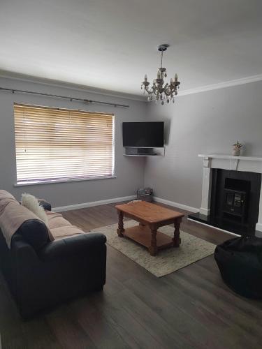 a living room with a couch and a coffee table at Teach Abhaile Donegal 