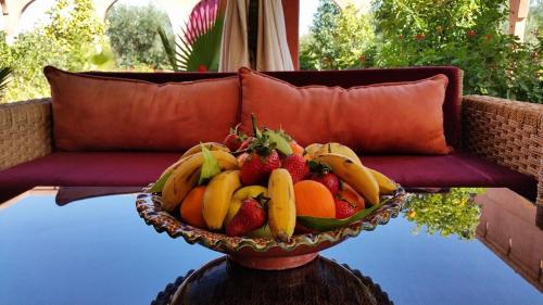 a bowl of fruit on a table in front of a couch at Ksar Salha in Marrakech