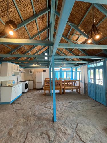 a large room with a table and a bench in it at Camping Casa Lipoveanului in Chilia Veche
