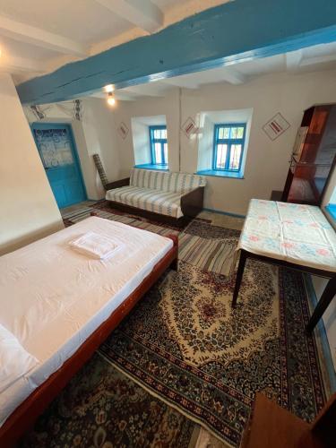 a room with two beds and a rug at Camping Casa Lipoveanului in Chilia Veche