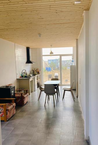a kitchen and dining room with a table and chairs at early afternoon Boutique Stay in Ferrel