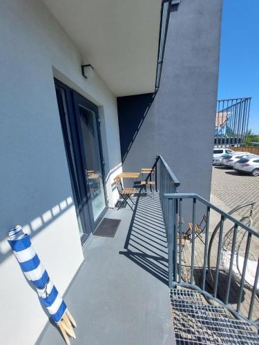 a stairway with a blue and white pole next to a building at Ludna 27 in Niechorze
