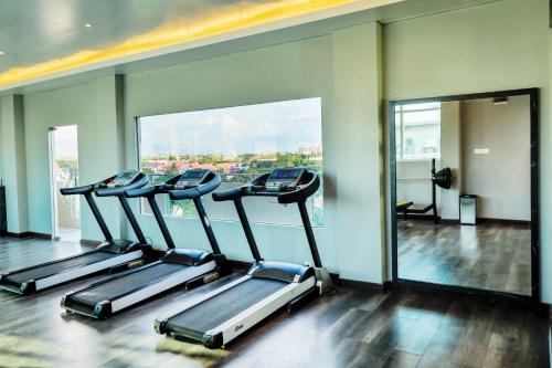 a row of treadmills in a gym with a window at Grand Sya Hotel in Palu