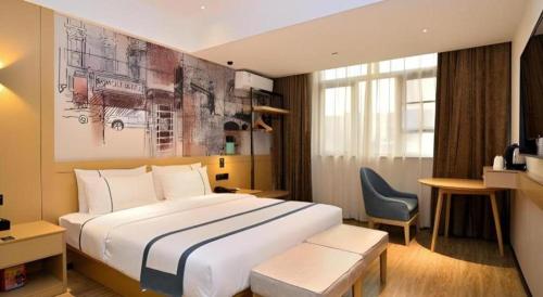 a hotel room with a large bed and a chair at City Comfort Inn Kunming Nanping Pedestrian Street Wangfujing in Kunming