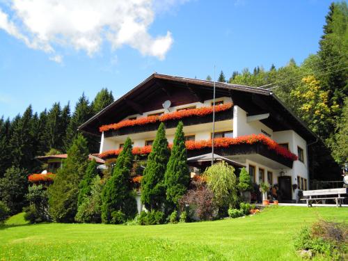 a house with flowers on the side of it at Pension Sonnhof in Radstadt