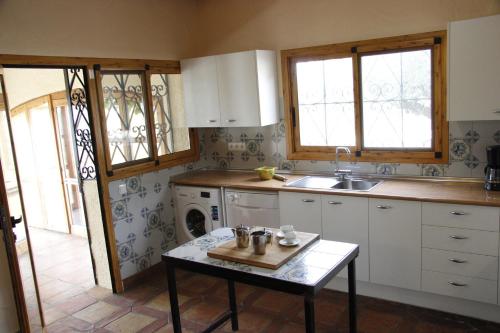 a kitchen with a sink and a table in it at Casa Mola in Perelló