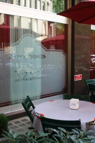 a table and chairs sitting in front of a window at Domus Hotel in Alessandria