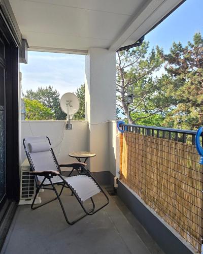a balcony with two chairs and a table and a window at 海の風 in Wakayama