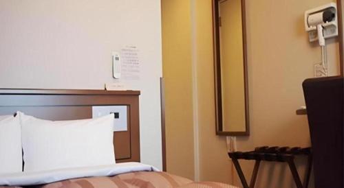 Кровать или кровати в номере Hotel Route Inn Hirosaki Ekimae