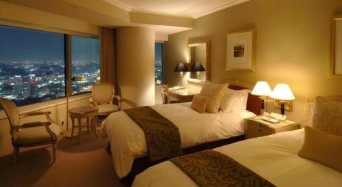 a hotel room with two beds and a large window at Yokohama Royal Park Hotel in Yokohama