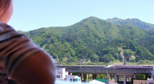 a person looking out of a window at a train at Yuzawa New Otani in Yuzawa