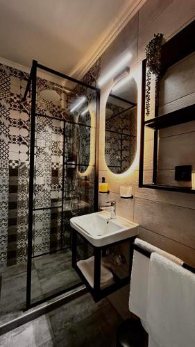 a bathroom with a sink and a shower at Centralsuiteaxd in Alexandroupoli