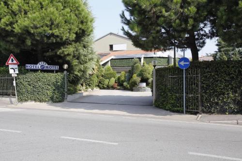 a gate to a house with a sign on it at Hotel City Legnano in Legnano