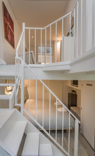 a white spiral staircase in a house at Luxury Flower Market Apartment in Amsterdam