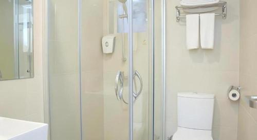 a bathroom with a shower and a toilet and a sink at London Hotel in Macau