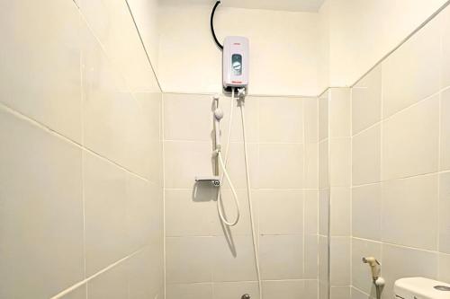 a bathroom with a shower with a phone on the wall at Pilot Hotel in Alaminos