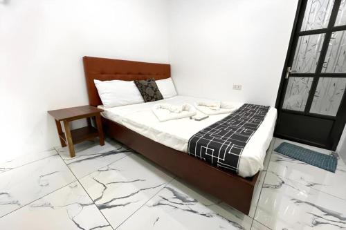 a bedroom with a bed with marble floors at Pilot Hotel in Alaminos