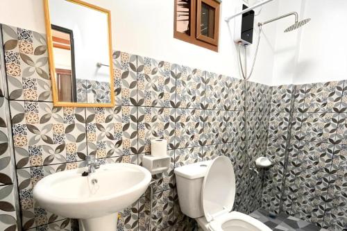a bathroom with a toilet and a sink at Pilot Hotel in Alaminos