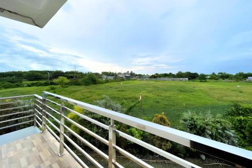 a view of a field from the balcony of a house at Pilot Hotel in Alaminos