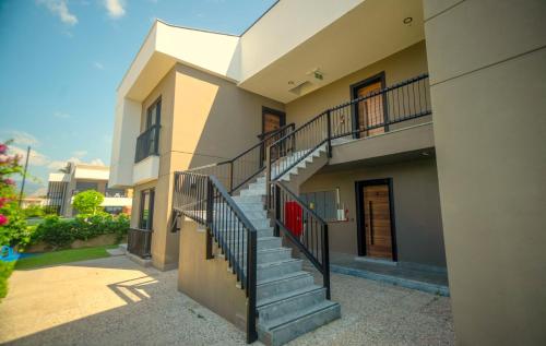 a building with a staircase in front of it at Camyuva Beach Hotel in Kemer