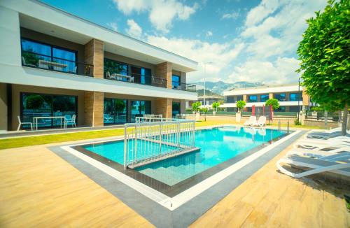 a swimming pool in front of a building at Camyuva Beach Hotel in Kemer