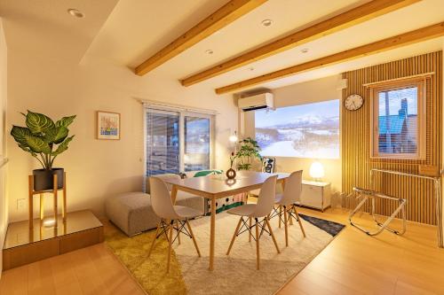 a dining room and living room with a table and chairs at Cozy Stay Asahikawa in Asahikawa