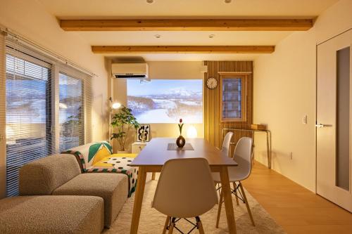 a living room with a table and a couch at Cozy Stay Asahikawa in Asahikawa