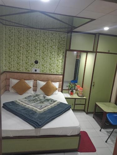 a bedroom with a bed with a blue blanket on it at relax in Shimla