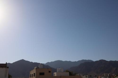 a view of a city with mountains in the background at Extra Traveller in Aqaba